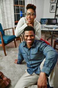 What is sex coaching? Image shows two people laughing, smiling, and looking at the camera.