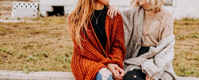 Two friends happily discuss the power of sex coach peer support.