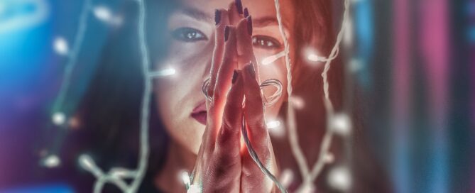 a-woman-practices-spiritual-bdsm-by-tying-her-hands-with-string-lights
