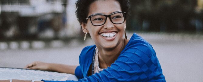 A woman smiles as she learns about pleasure language.