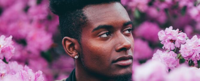 A man ponders the concept of energy in a field of flowers