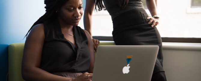 A woman reviews her email list strategy on a laptop.