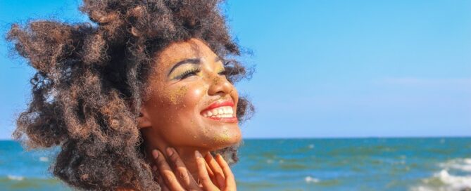 A woman smiles about the soothing benefits of self pleasure