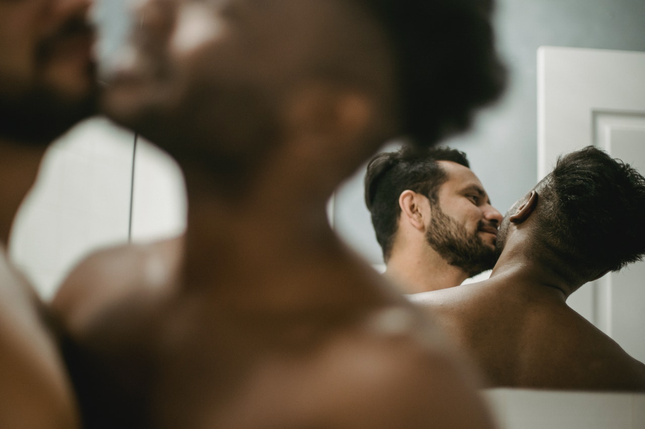 image of two men being playful in front of a mirror