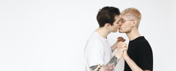 two men holding hands and kissing to show how pleasure products enhanced their relationship