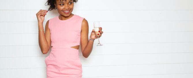 Image shows woman with glass half full, smiling at her narrative
