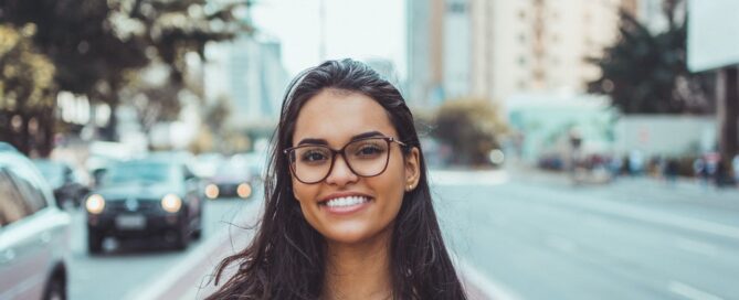woman smiling on the street because body neutrality can help her clients
