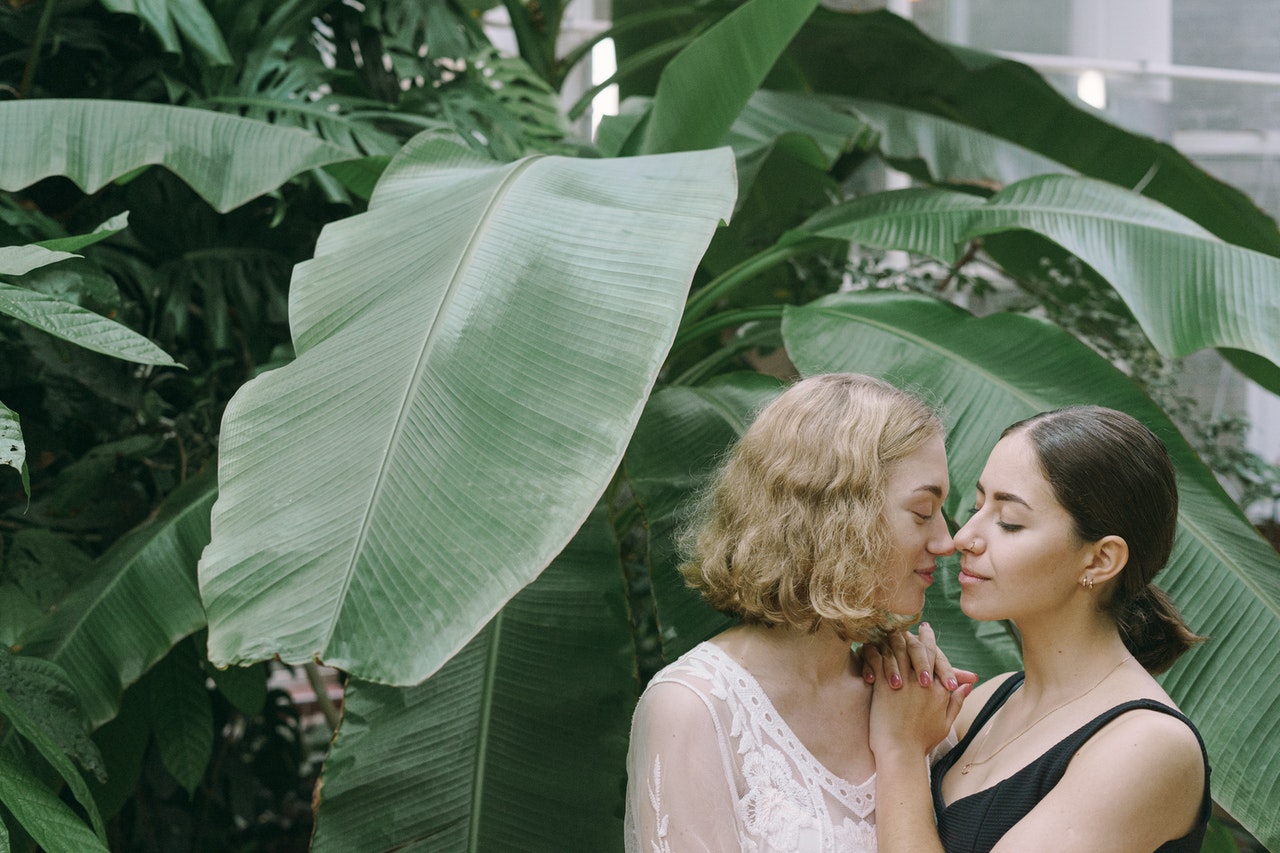 Two Aquarius women looking at each other longingly