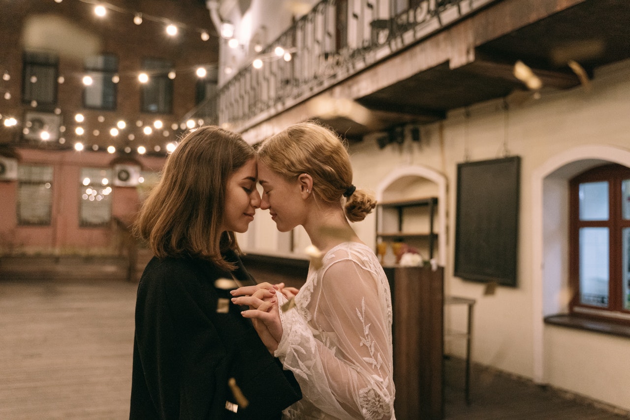 two Pisces women holding each other close