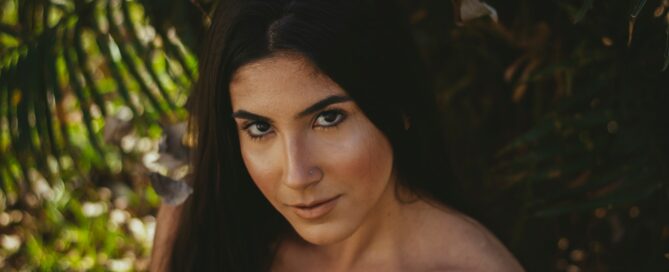 a woman in the trees looks up with a slight smile because she understands the five love languages
