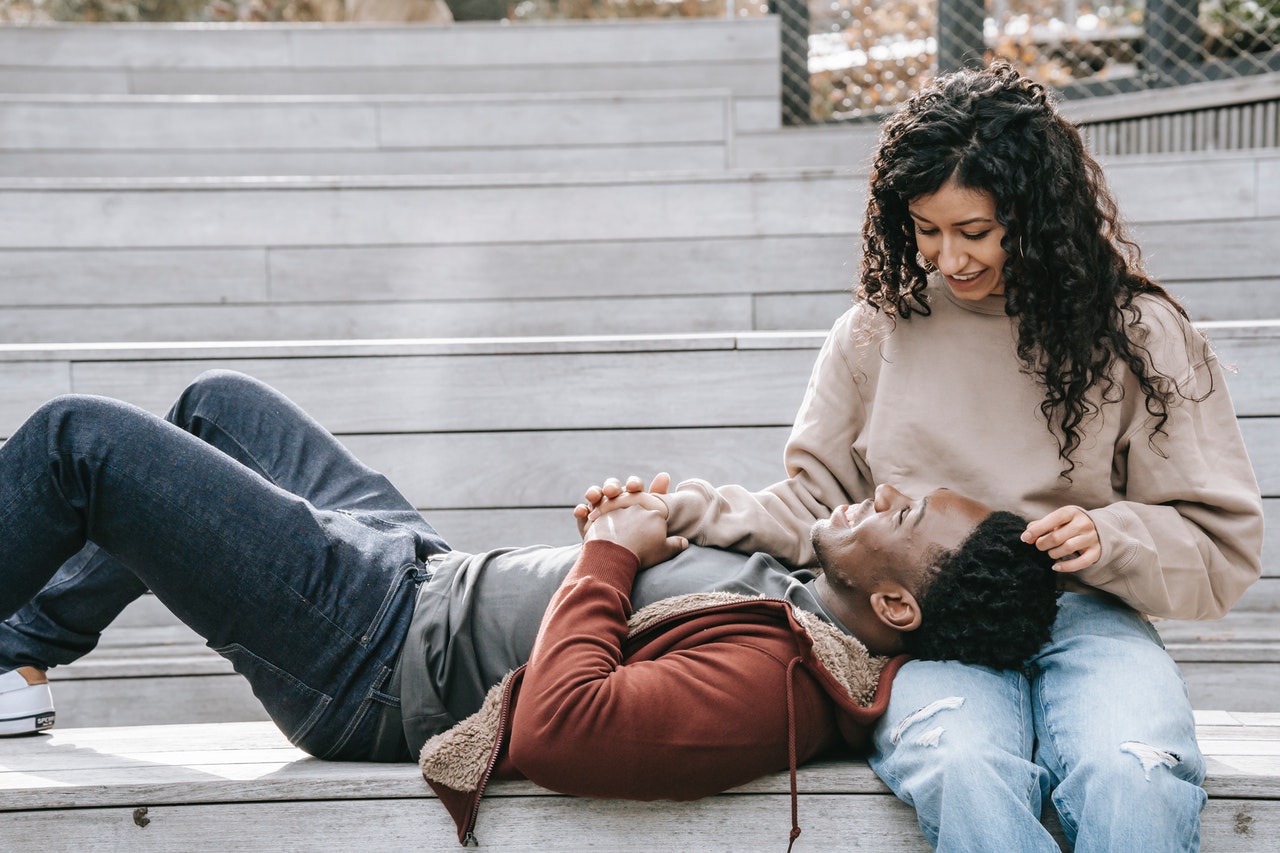 a man lays on a woman's lap representing Cancer relationship energy