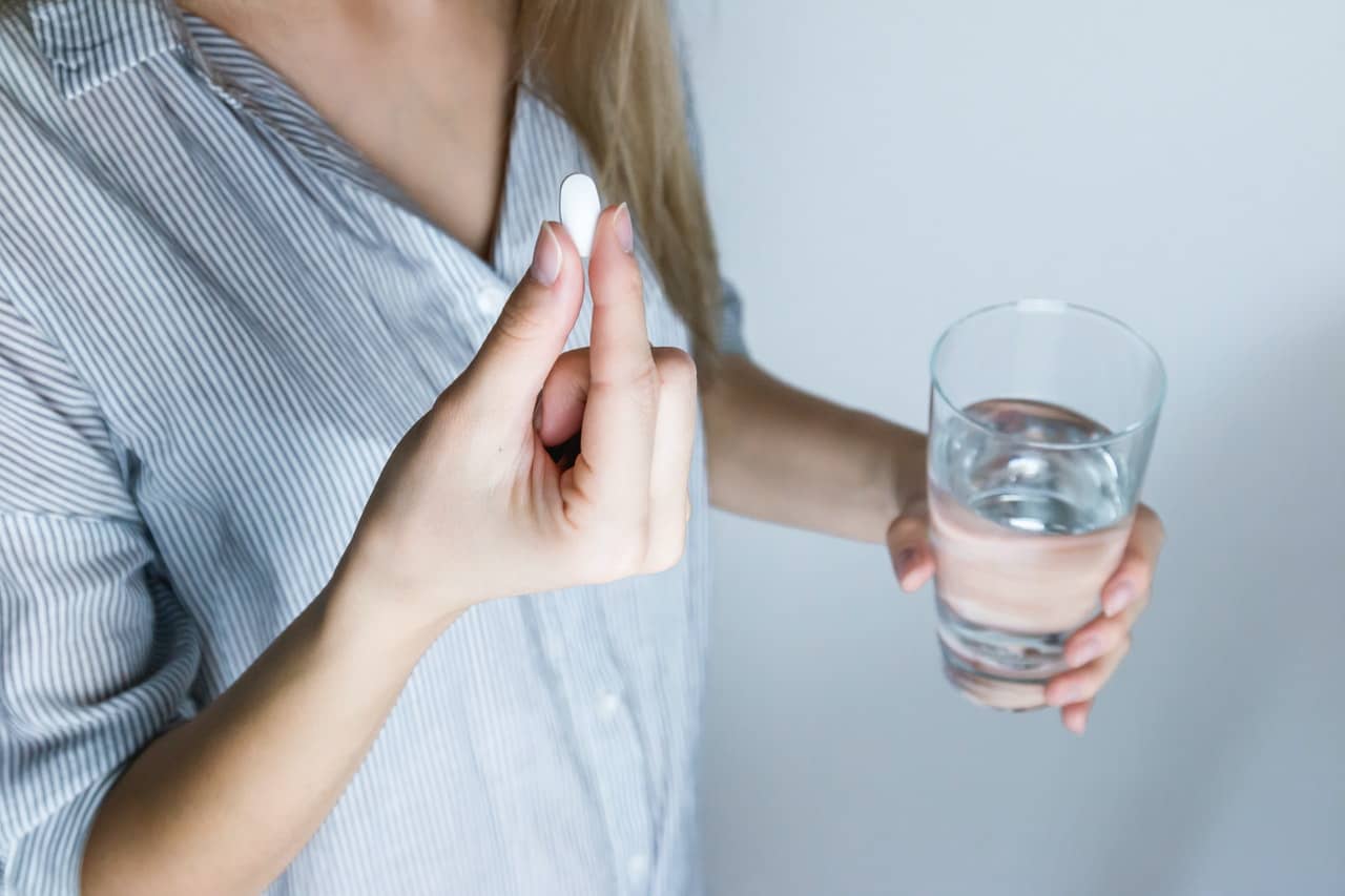 Image of a person taking a pill. STI stigma can be addressed, in part, through a thorough understanding of the preventions and treatments for STIs