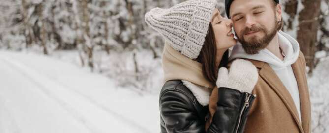 a happy couple in the snow after completing Sex coaching assignments for intimacy and connection in couples