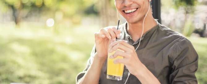 man sitting in a park with a drink using tips for studying at scu
