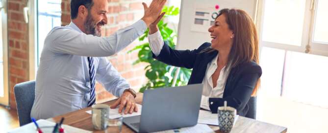 two professionals high fiving and after benefiting from practicing their skills with each other