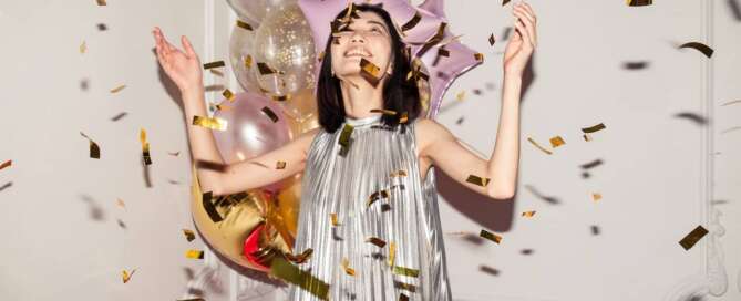 Woman celebrating with confetti because she is pivoting her career in the new year.