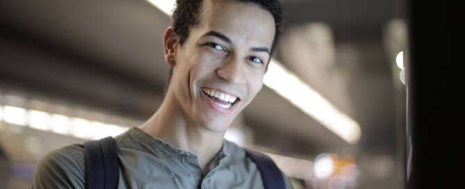 a man smiles brightly at the camera because he learned about coaching delayed ejaculation