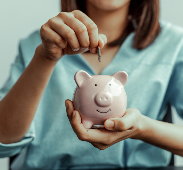 piggybank a women putting money in a piggy bank because they both became an scu ambassador.